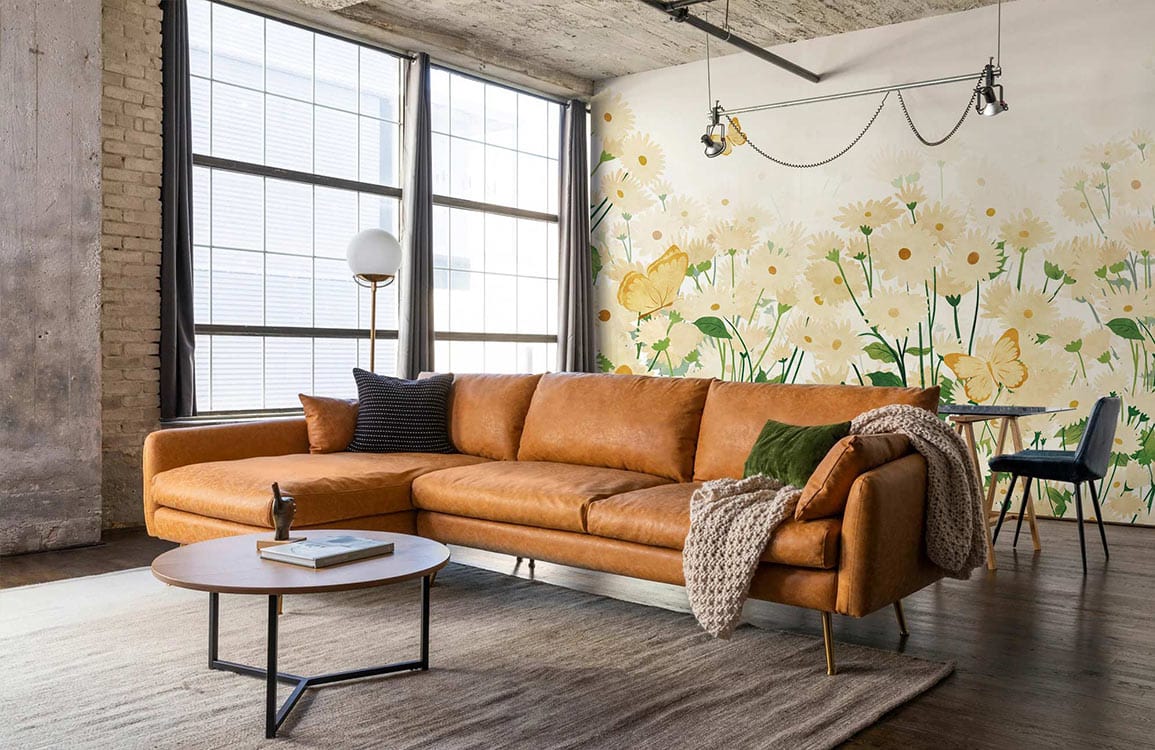 Floral Meadow Delight Mural, pastel yellow and green, brown sofa, industrial loft with modern decor.