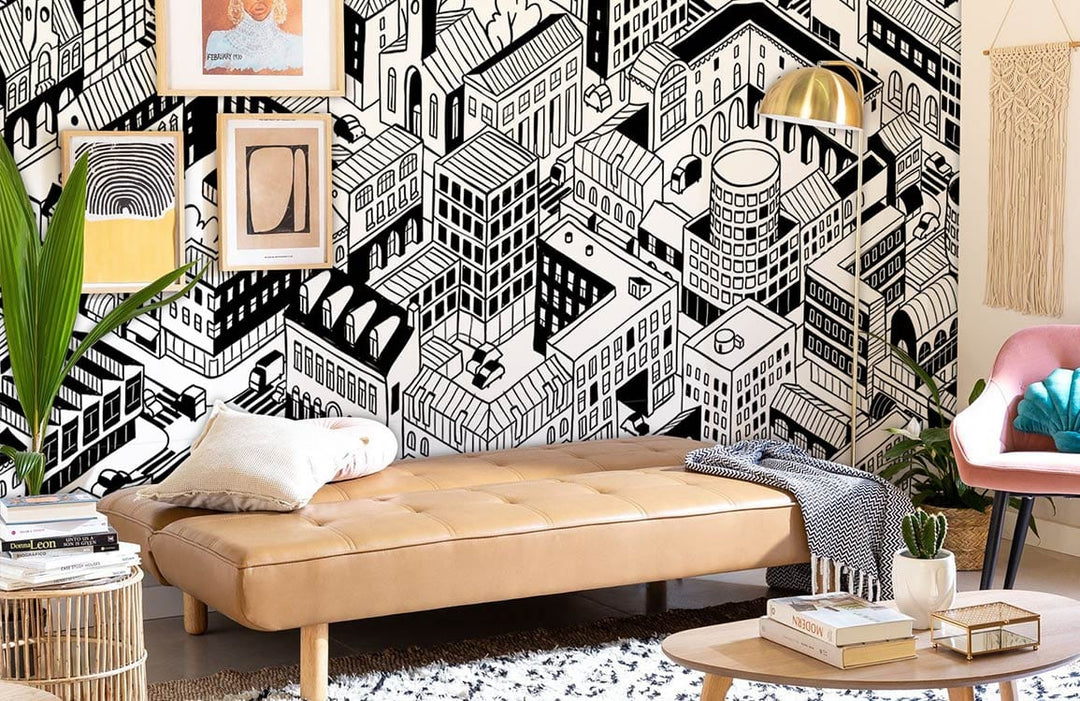 Monochrome urban landscape mural in living room; tan sofa, patterned rug, framed art, modern decor.