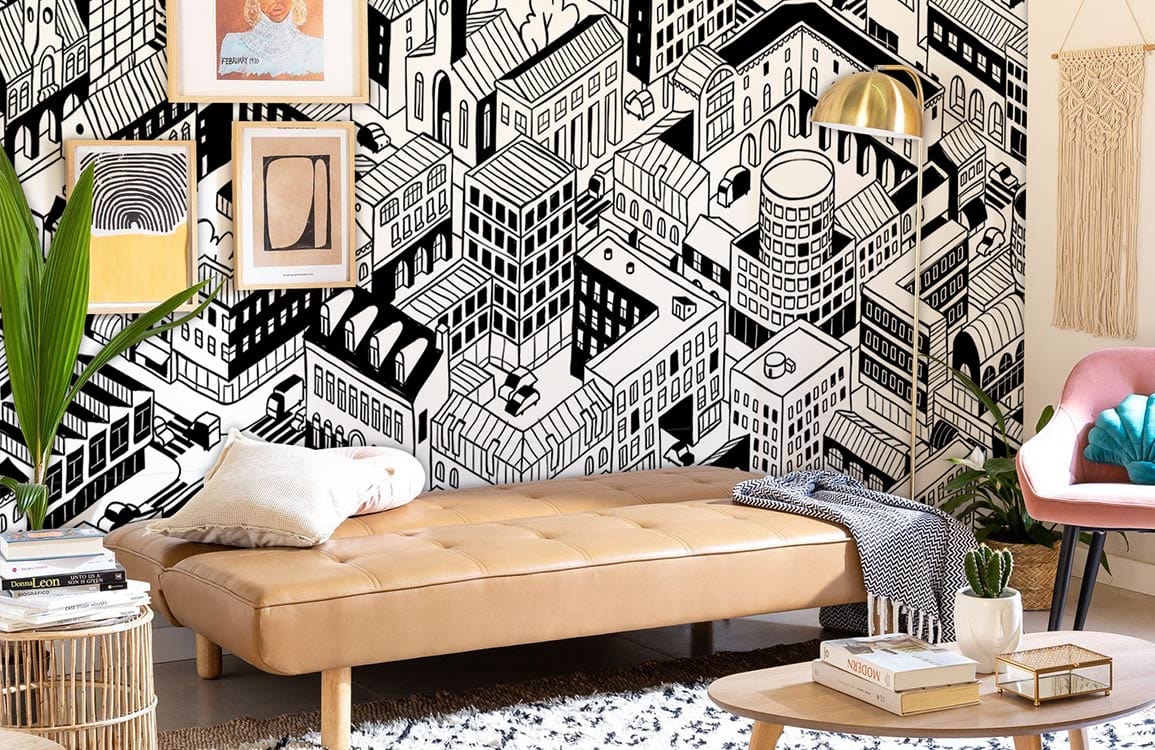 Monochrome urban landscape mural in living room; tan sofa, patterned rug, framed art, modern decor.