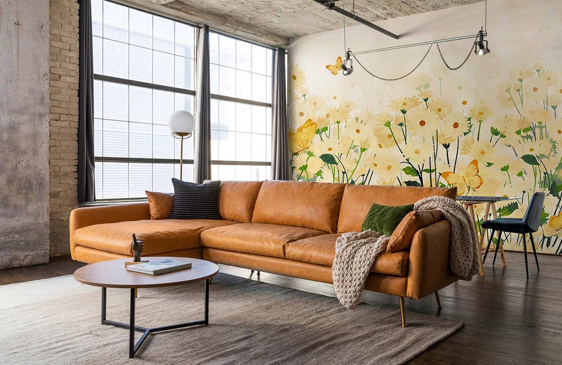 Loft with Creamy Floral Wallpaper, tan sofa, industrial windows, wooden flooring.