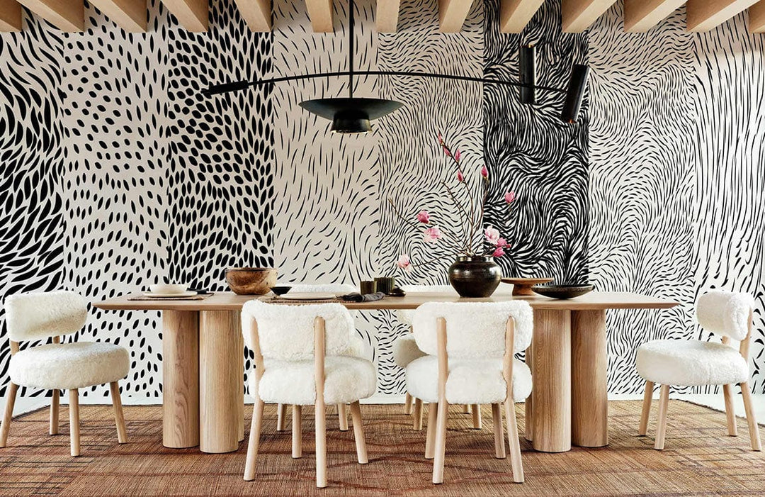 Monochrome abstract patterned wallpaper in modern dining room with wooden table and beige chairs.
