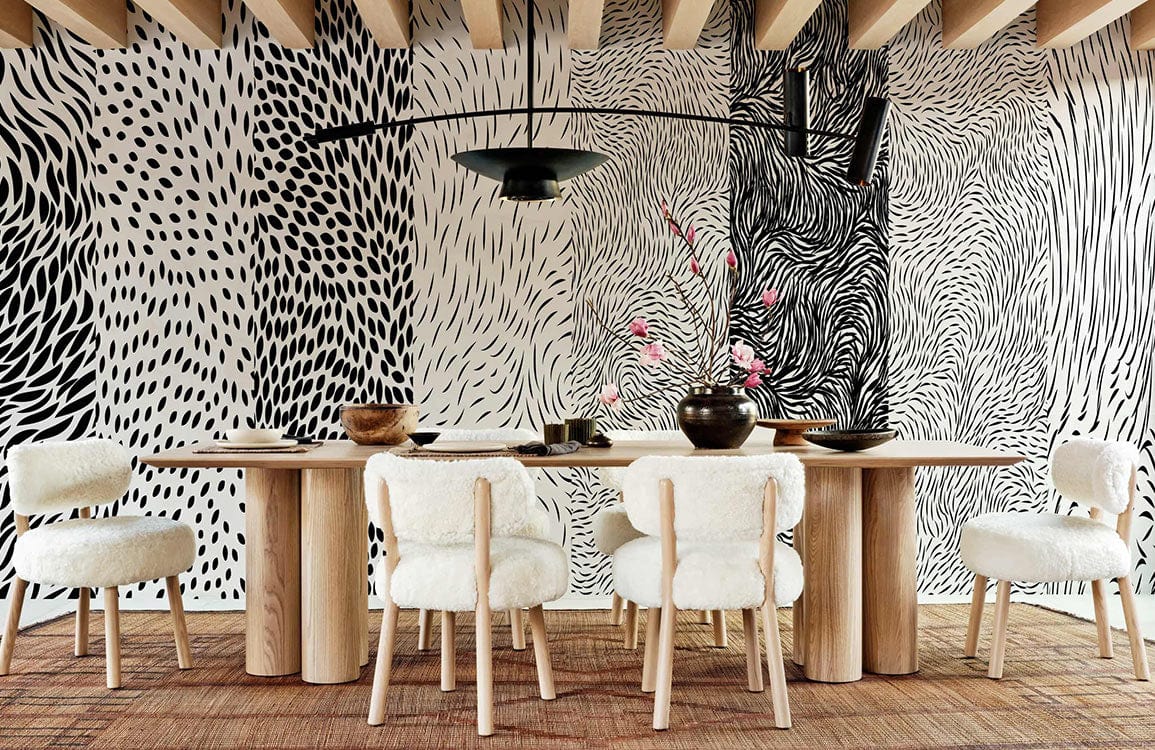 Monochrome abstract patterned wallpaper in modern dining room with wooden table and beige chairs.