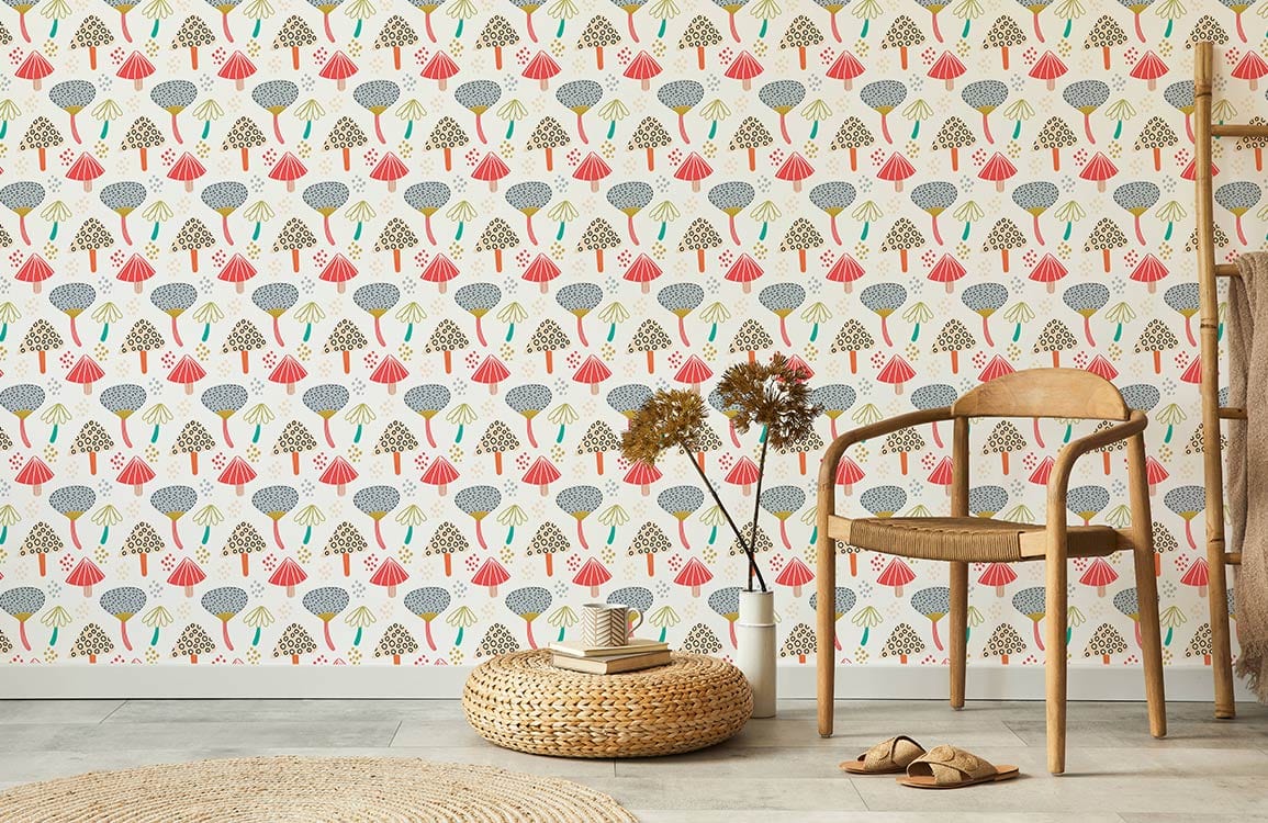 Vintage geometric tree wallpaper in room with light wood chair, neutral flooring, and woven ottoman.