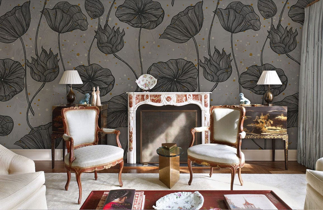 Grey botanical floral wallpaper in elegant room with vintage armchairs, marble fireplace, and wooden flooring.