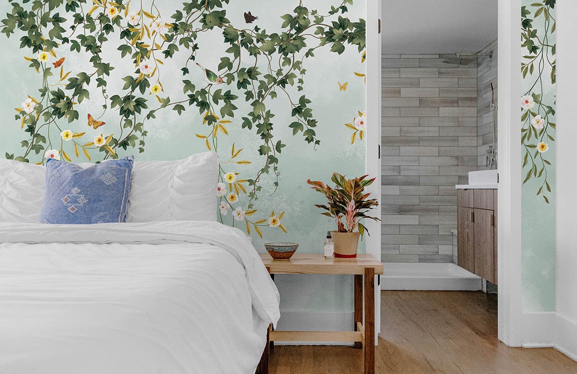 Vintage green floral vines wallpaper with butterflies and birds in modern bedroom, wooden flooring, blue cushion.