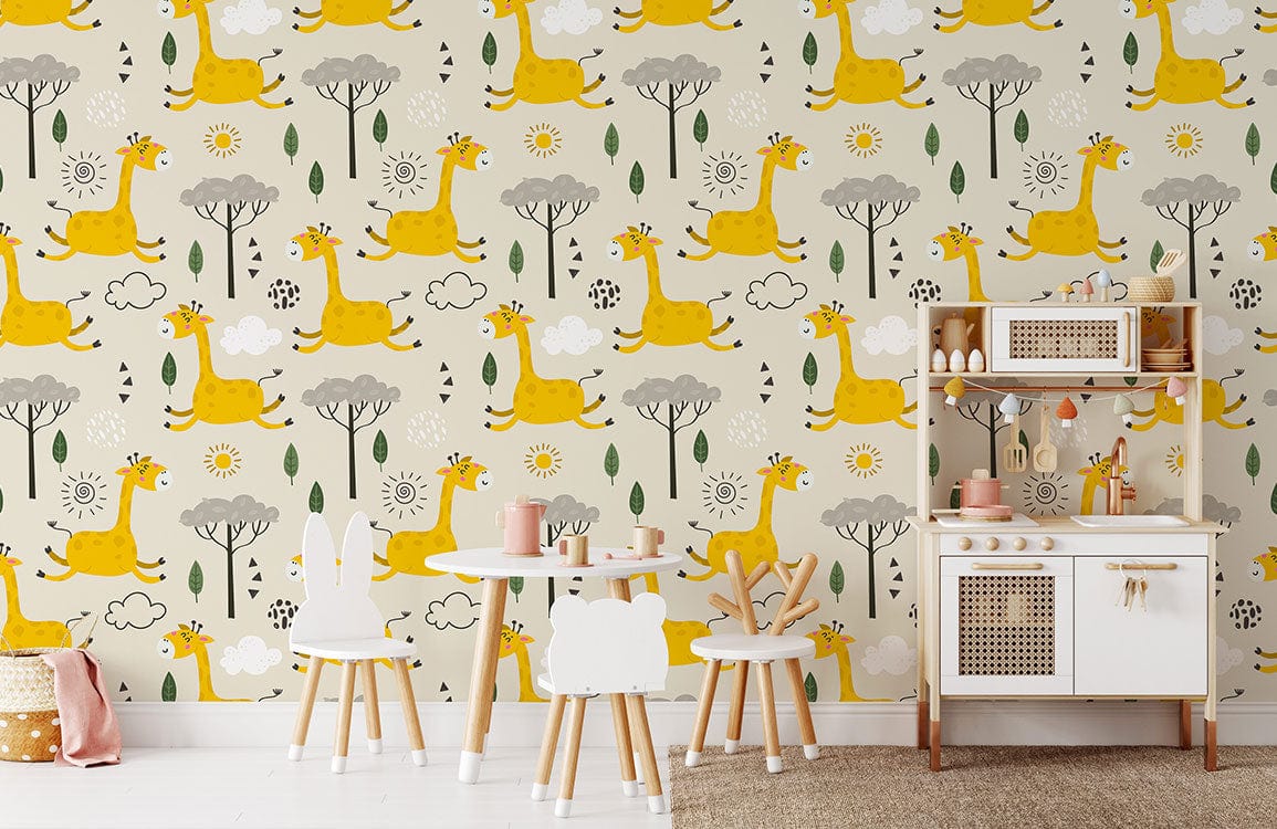 Whimsical giraffe safari wallpaper mural in bright children's bedroom with white table, chairs, play kitchen.