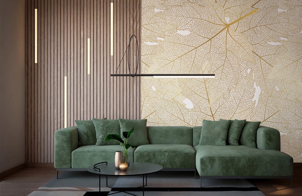 Elegant golden leaf wallpaper on wood-panel wall, green velvet sofa, modern lighting, stylish living room.