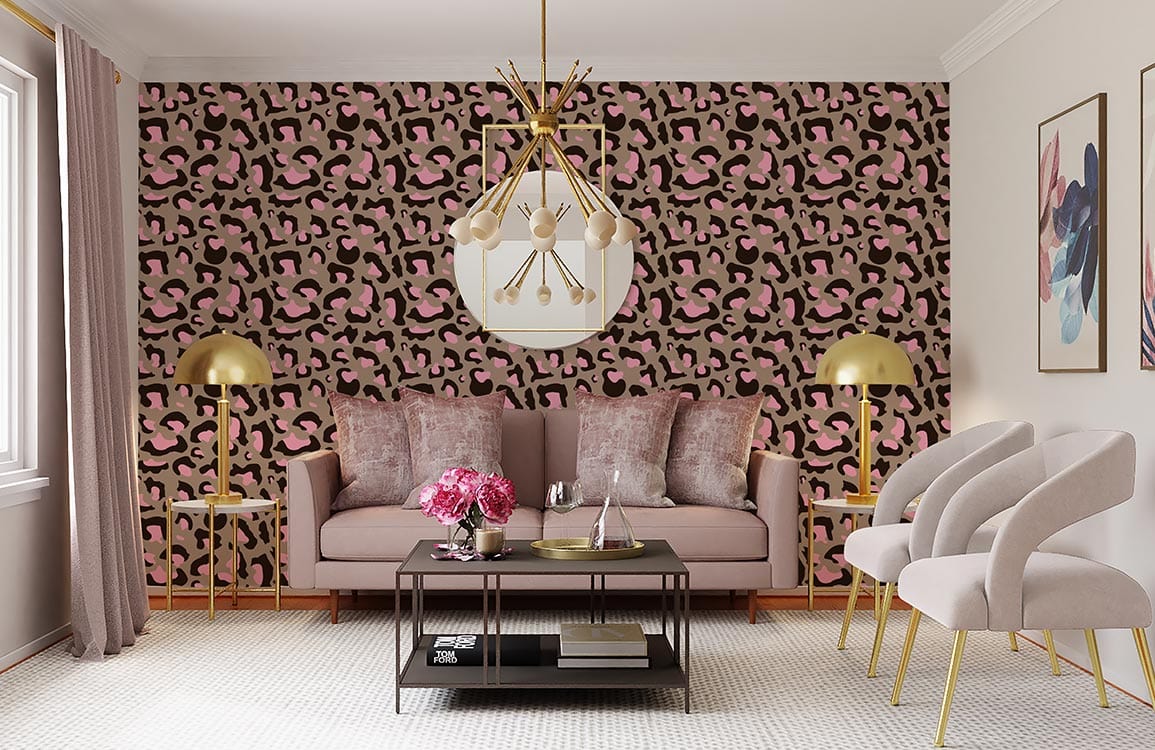 Pink and brown leopard print wallpaper in stylish living room with beige sofa, gold lamps, artwork.