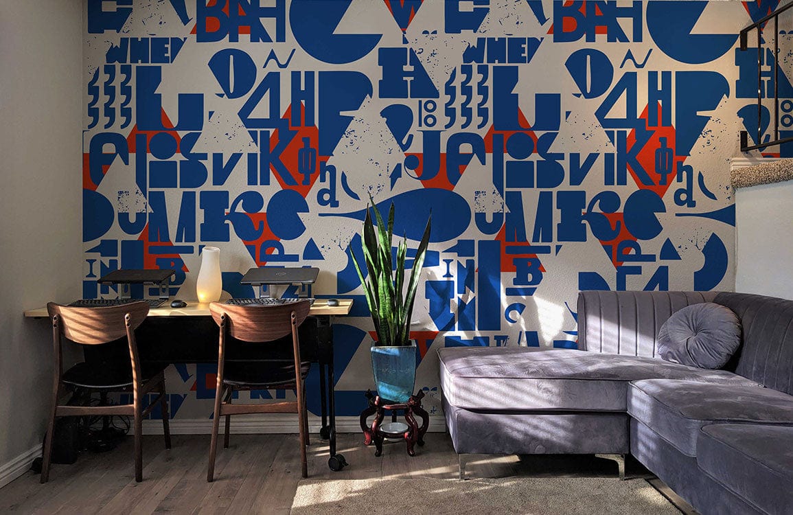 Contemporary blue and red geometric mural wallpaper with grey sofa, dark wood chairs, and light wood flooring.