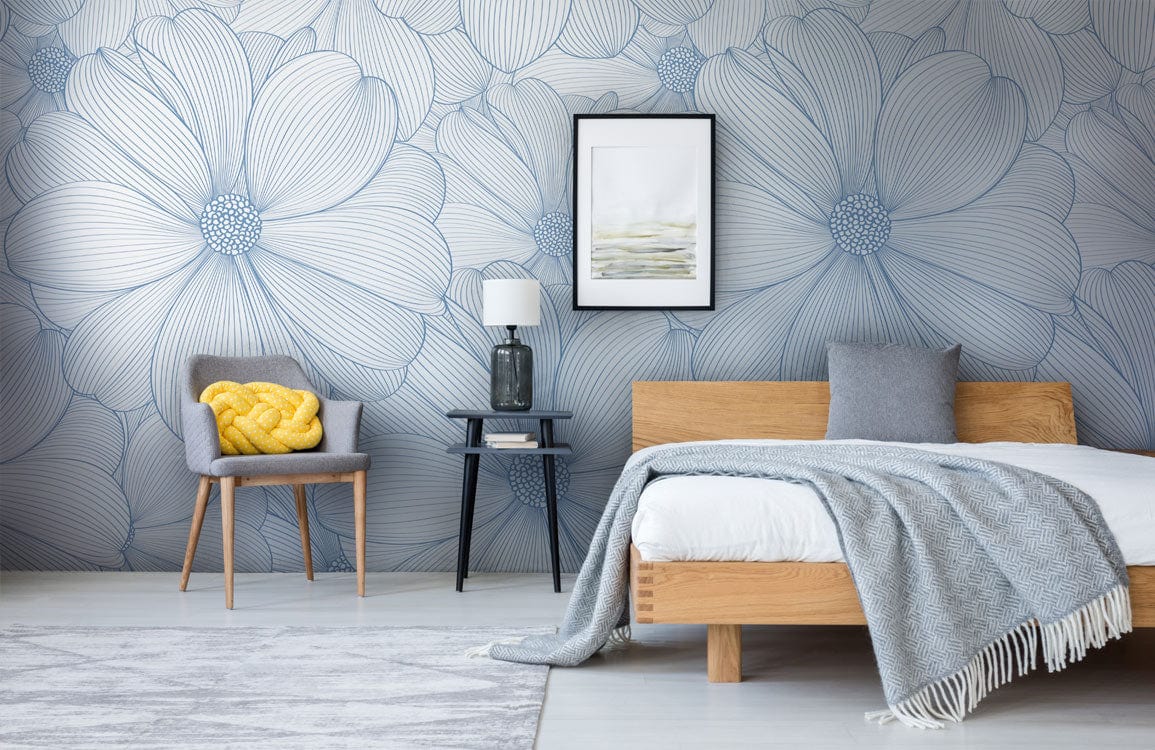 Elegant blue floral wallpaper in modern bedroom, grey chair, wooden bed, framed artwork, wooden flooring.