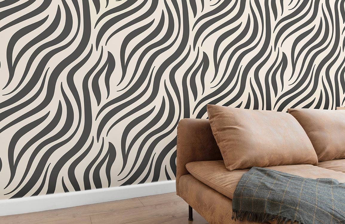 Monochrome zebra stripe wallpaper with tan sofa, wooden floor in a contemporary living room setting.