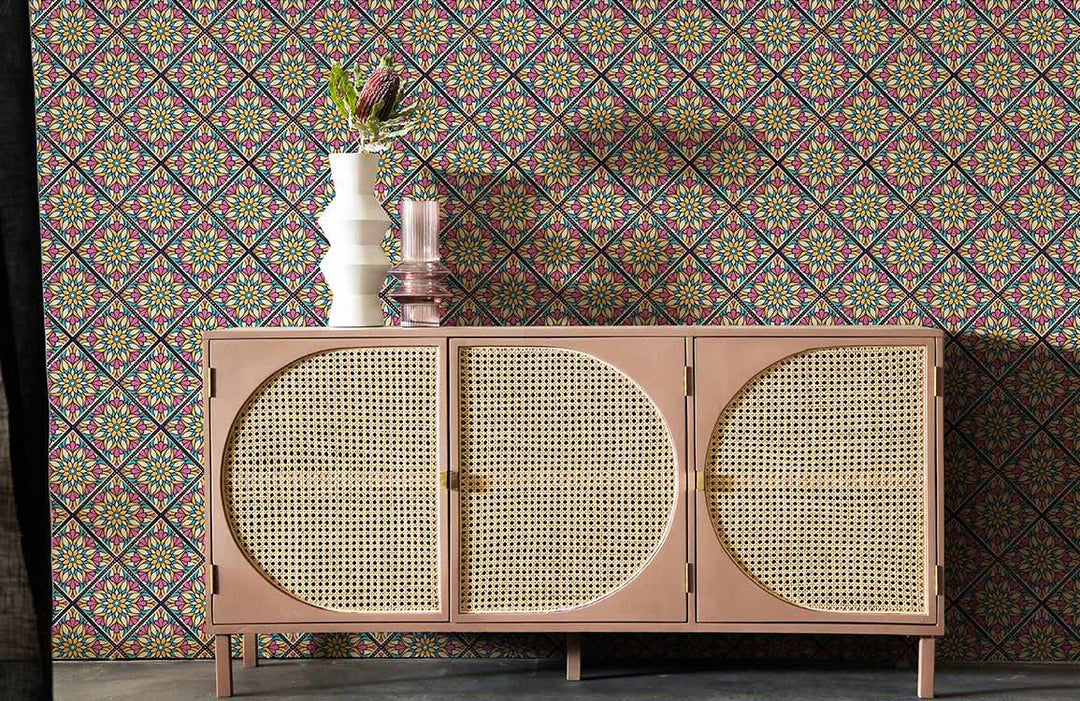Colourful geometric floral wallpaper with a retro sideboard on grey flooring in a stylish room.
