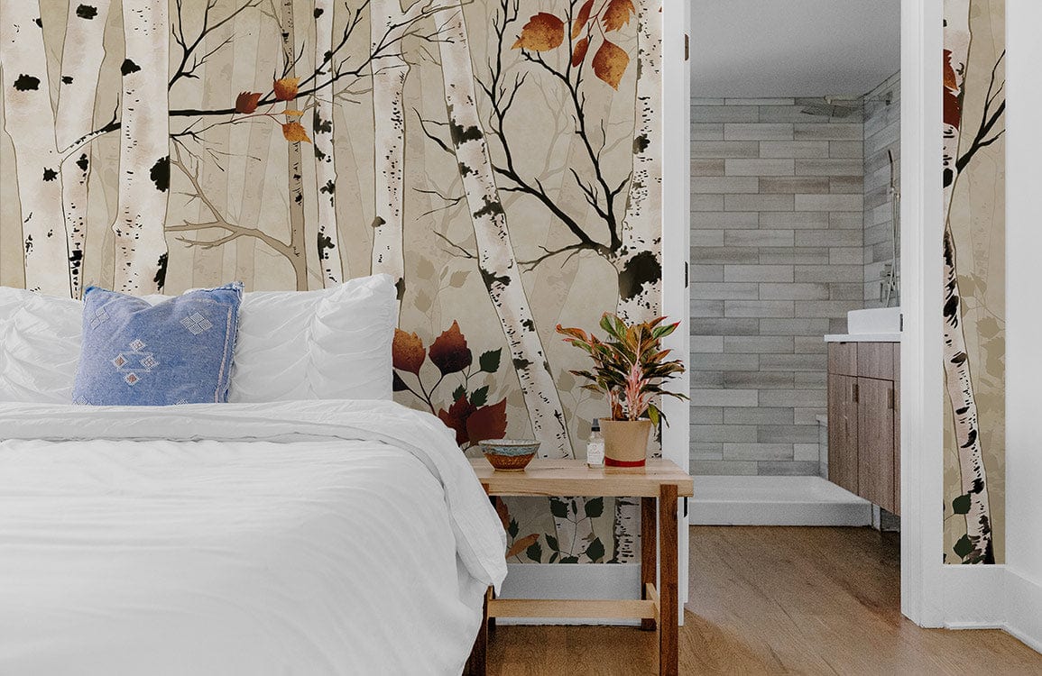 Autumn birch tree mural in bedroom with wooden flooring, white bedding, blue cushion, and plant decor.