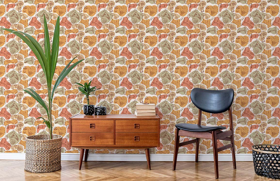 Autumnal Leaf Motif Wallpaper, warm earthy tones, wooden cabinet, black chair, herringbone wood flooring.