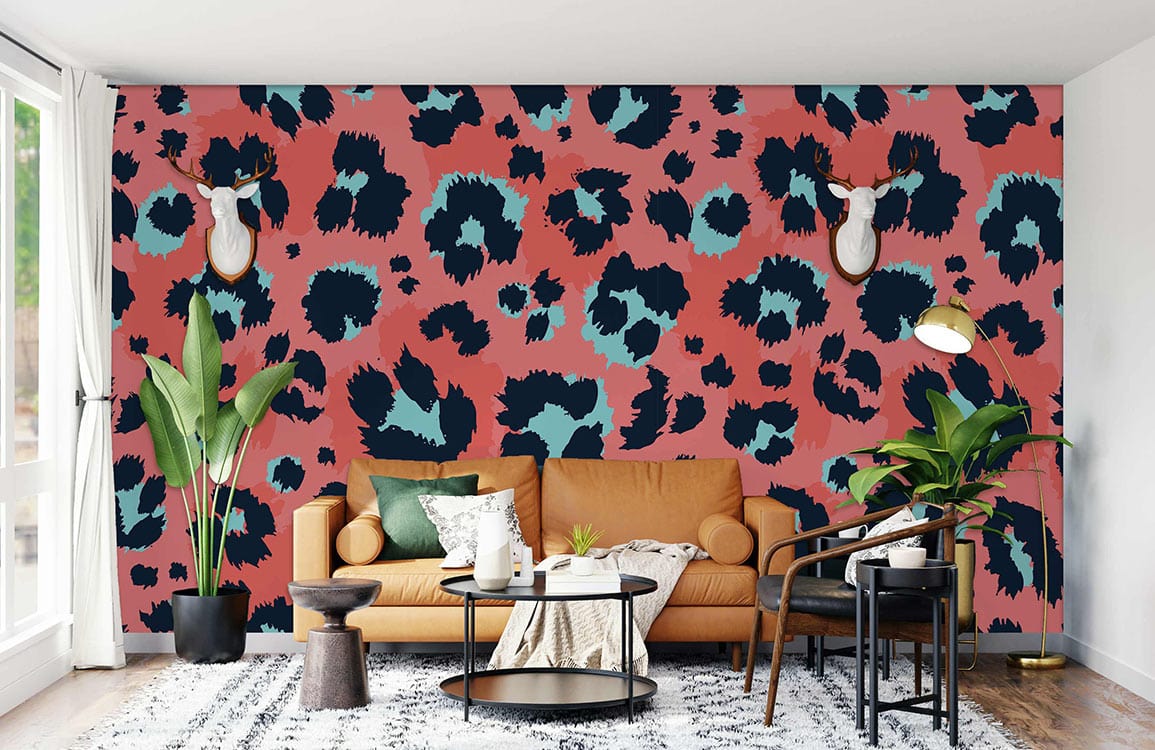 Bold Coral and Navy Leopard Print Wallpaper with tan sofa and round coffee table in living room.