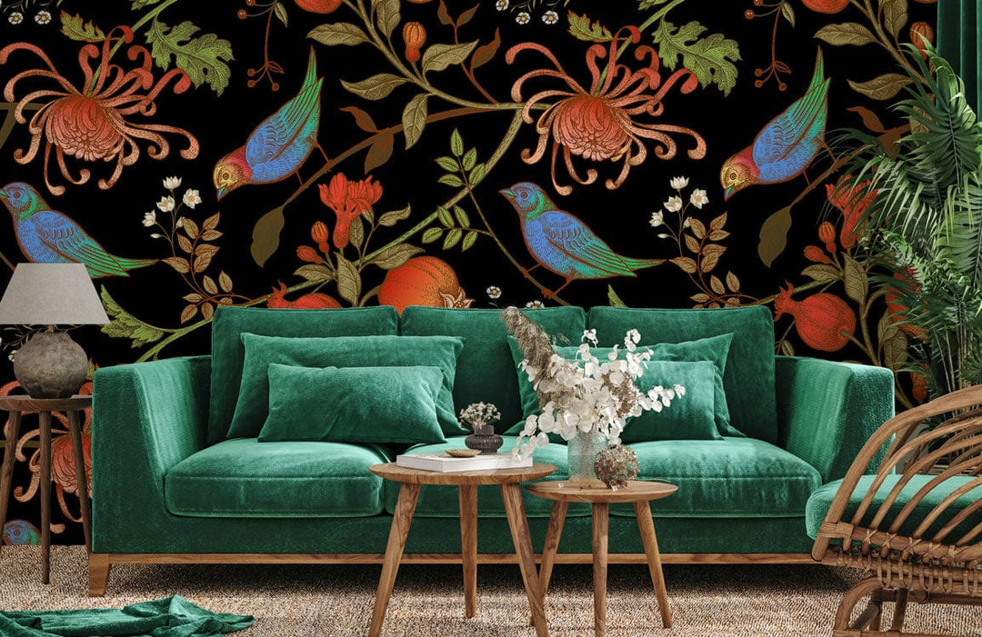 Vintage floral bird wallpaper, autumn hues; green velvet sofa, wooden tables; cosy living room.