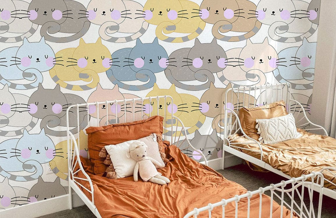 Pastel Whimsical Cat Pattern Wallpaper with white metal beds, orange bedding, neutral tones in children's room.