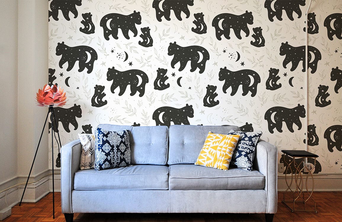 Gray sofa with cushions against Woodland Bear Night Sky Mural Wallpaper, monochrome, nature-inspired, wooden flooring.
