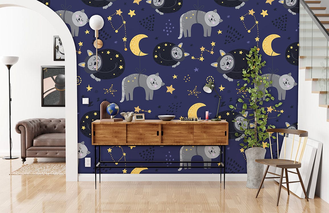 Dreamy Night Sky Cats Mural Wallpaper features navy blue with gold stars, brown console, grey sofa.