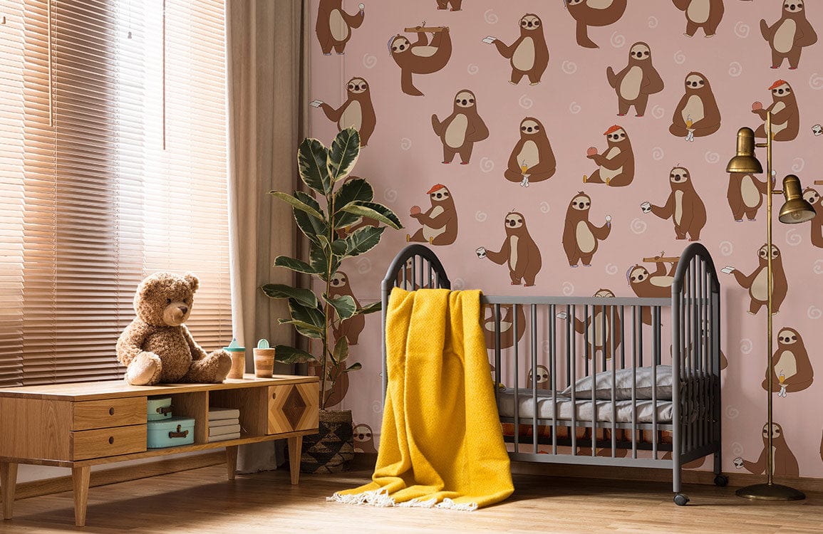 Whimsical sloth wallpaper, soft pink; kids' room; grey crib; wooden dresser; playful decor; warm lighting.