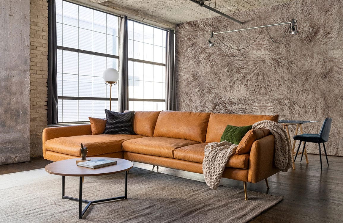 Luxurious faux fur grey wallpaper in living room with brown leather sofa, modern coffee table, large windows.