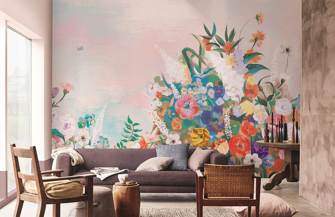 Elegant pastel floral garden mural wallpaper in modern living room with grey sofa, wooden chairs, rustic walls.
