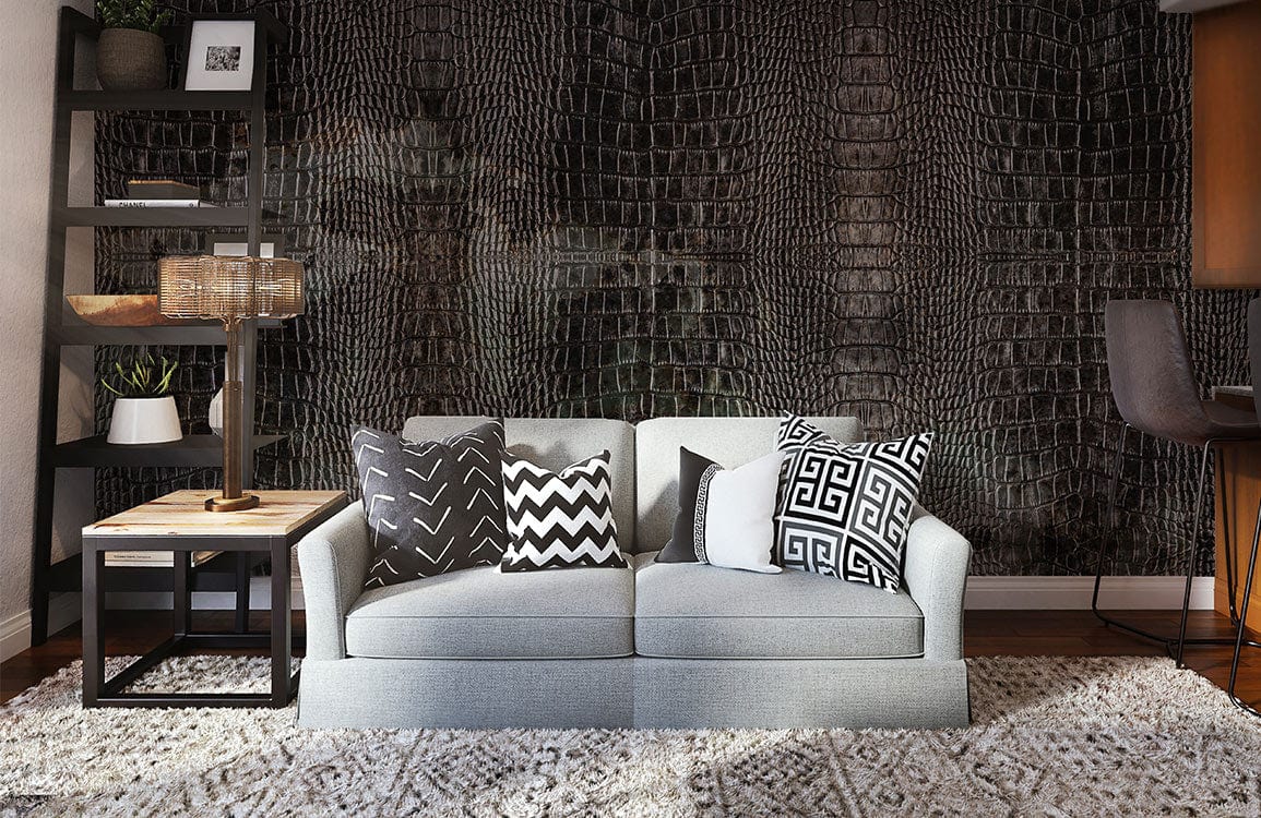 Luxury grey crocodile skin wallpaper in modern living room with grey sofa, patterned cushions, wooden flooring.