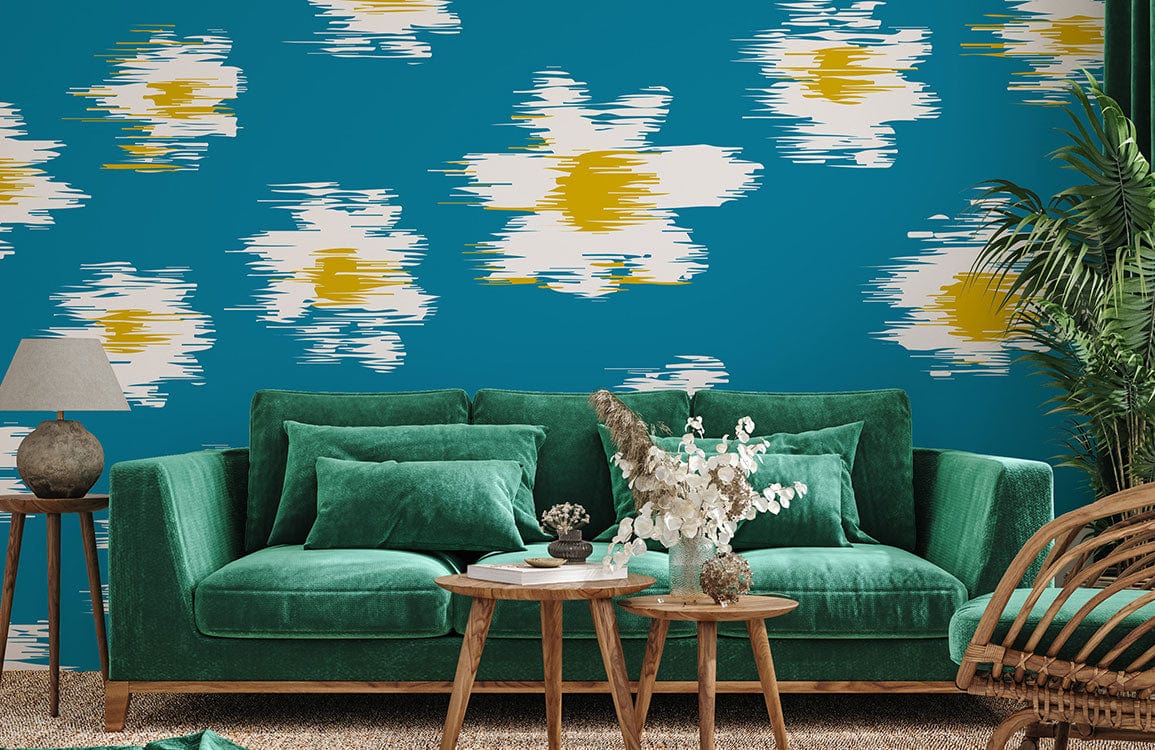 Bold teal floral wallpaper, vintage-style daisies, complemented by green velvet sofa, wicker chair, carpet.