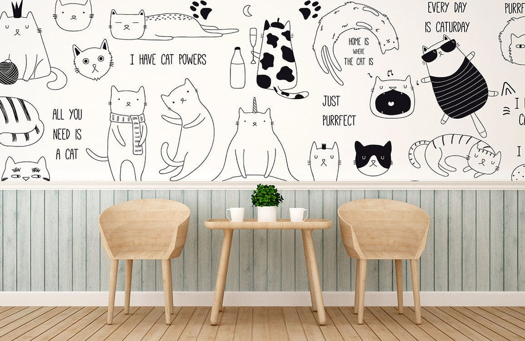 Playful cat mural wallpaper in bedroom with light wood chairs, table, and striped blue wall panelling.