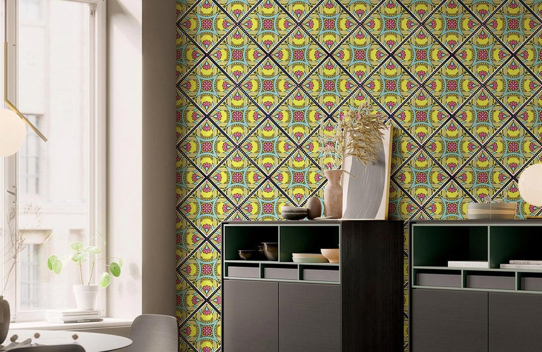 Vibrant geometric kaleidoscope wallpaper in yellow, purple tones; modern room, grey cabinets, round table.