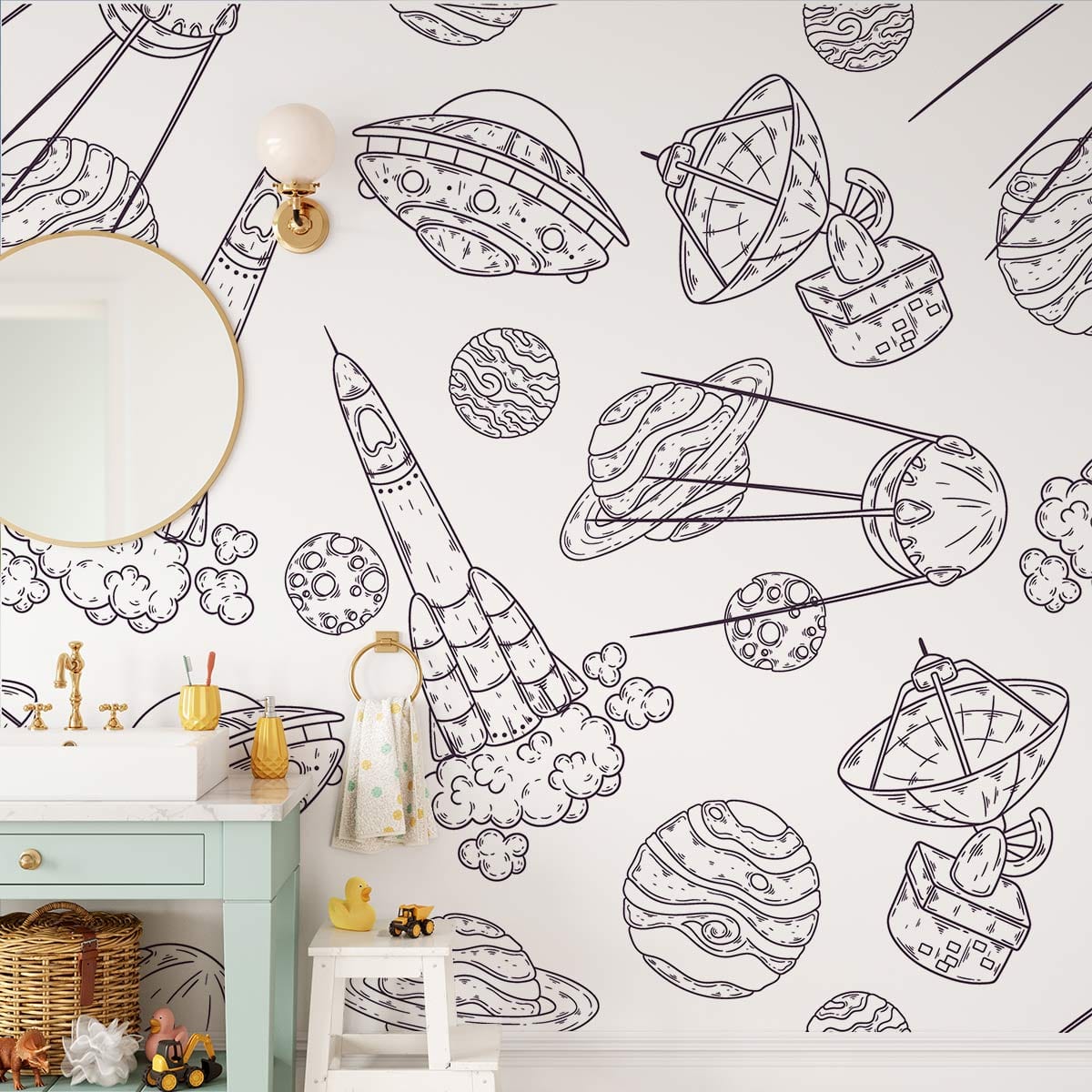 Monochrome children's space-themed mural wallpaper with rockets, planets; mint vanity, wall lights, bathroom setting.