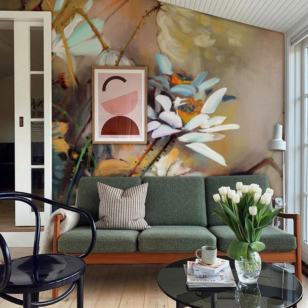 Elegant floral mural wallpaper with daisies, green sofa, abstract wall art, light wood flooring, stylish room.