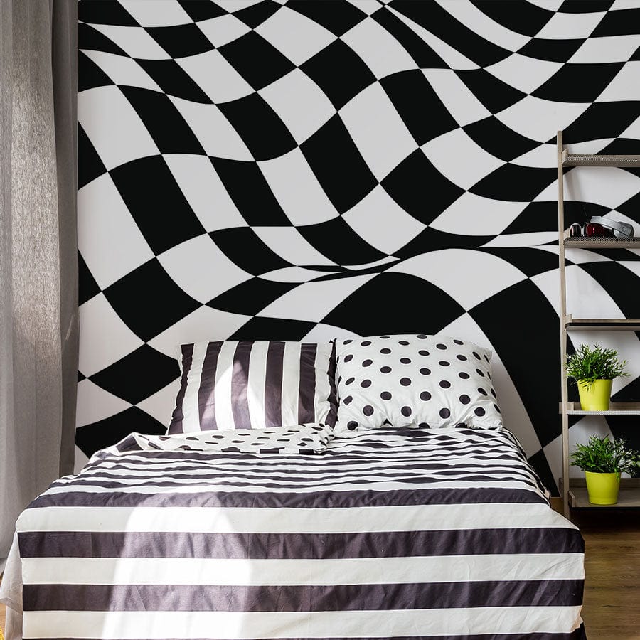 Abstract black and white checkered optical illusion wall mural in bedroom with striped bedding and shelves.