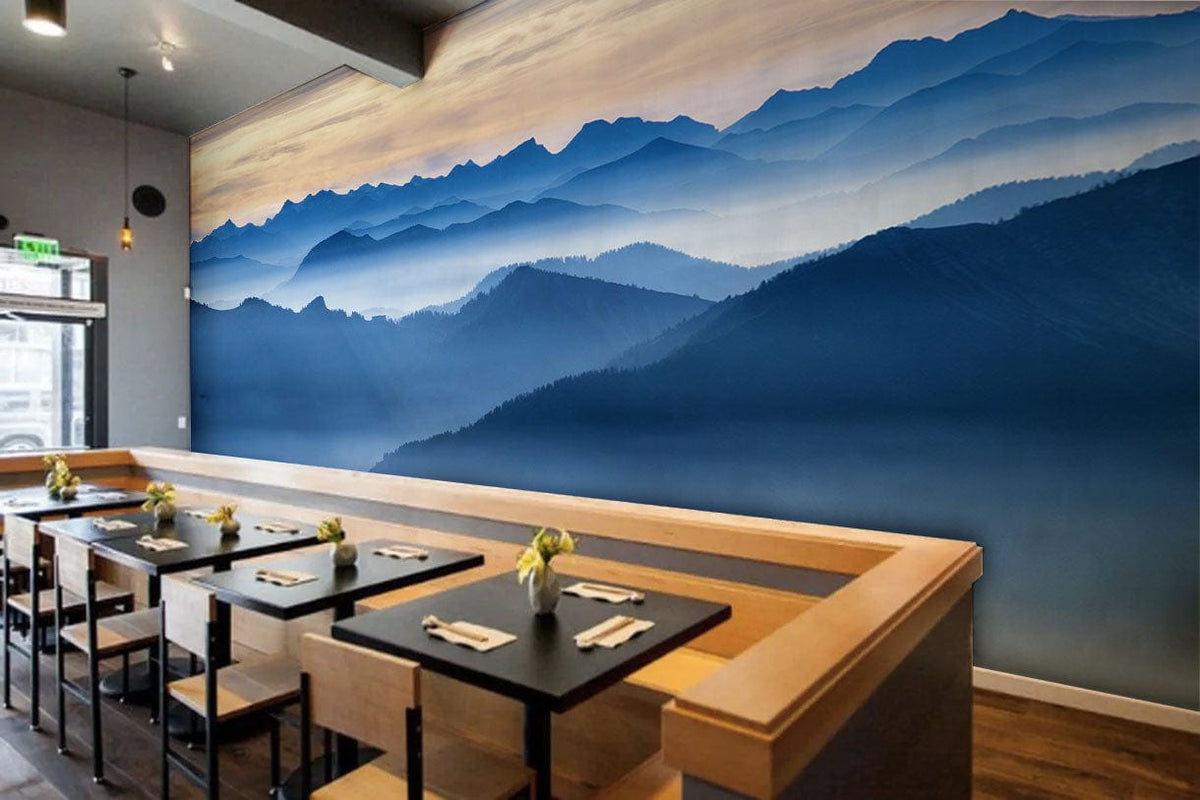 Serene Blue Mountain Landscape Mural in dining area with wooden tables and modern black chairs.