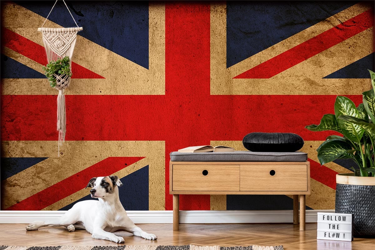Vintage Union Jack Mural Wallpaper with dresser, hanging decor, dog, wooden flooring, and greenery accents.