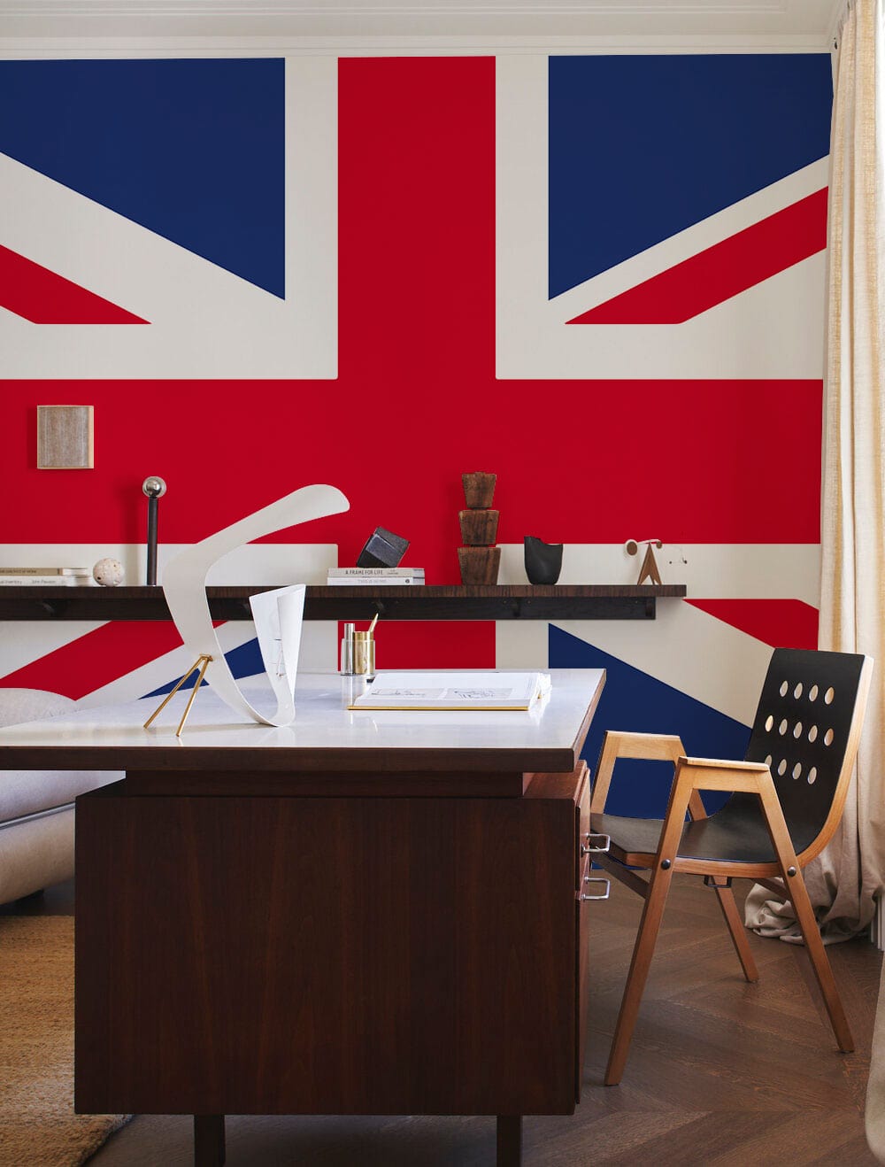 Flag wall with modern desk, wooden chair, and art decor, in a contemporary workspace setting.