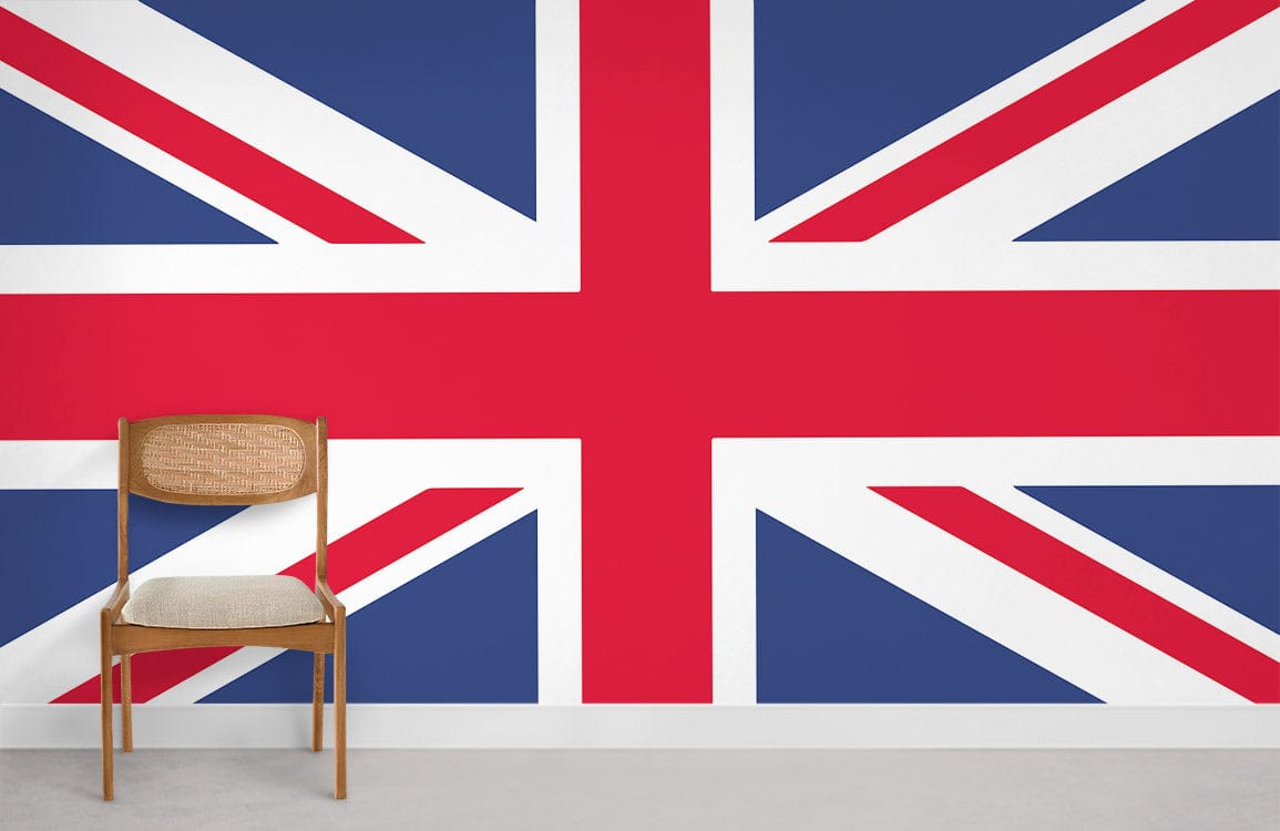 Union Jack flag mural with wooden chair on light carpet, minimalist room setting.