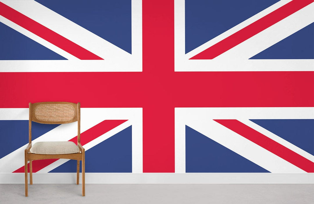 Union Jack flag mural with wooden chair on light carpet, minimalist room setting.