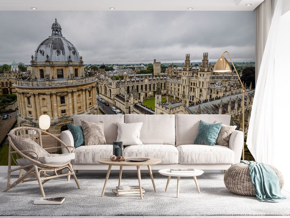 Classic British university architecture wallpaper in grey tones, stylish living room with beige sofa, grey rug.