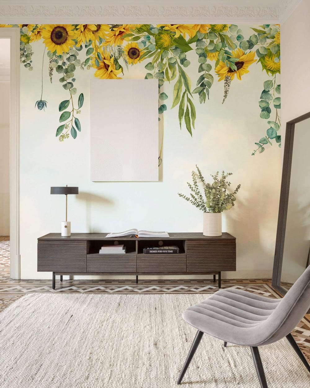 Sunny Floral Bliss Wallpaper: Botanical mural in living room with grey chair, modern console, geometric flooring.