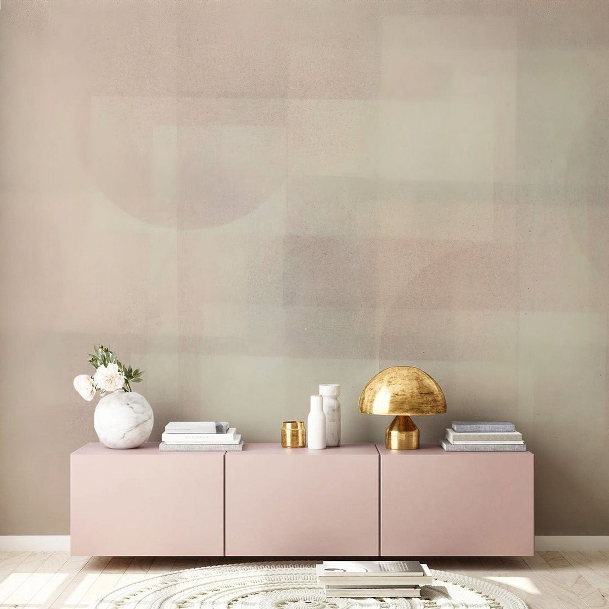 Subtle geometric pastel abstract wallpaper in a modern living room with light pink sideboard and rug.