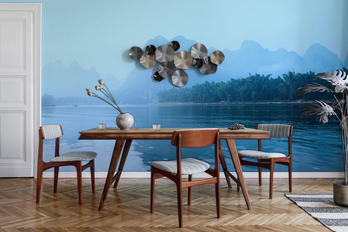 Tranquil Misty Blue Mountain Landscape Mural in dining room; wooden chairs; herringbone floor; metal wall art.