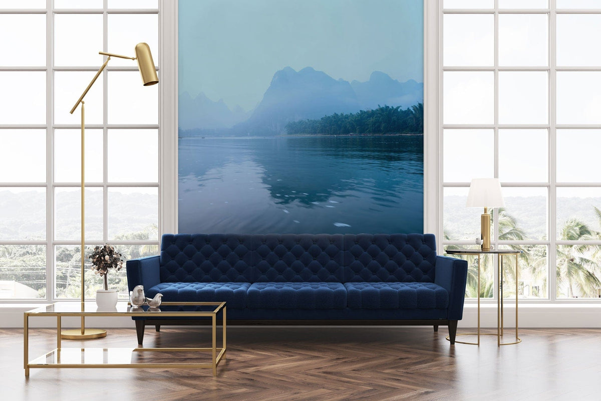 Tranquil Misty Blue Mountain Mural within modern room, featuring blue sofa, glass table, parquet flooring.