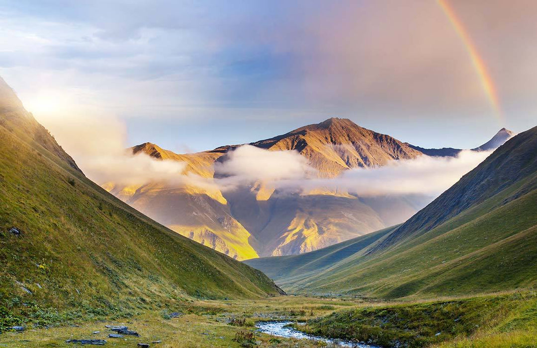 Serene Mountain Landscape Mural Wallpaper with Rainbow and Golden Glow