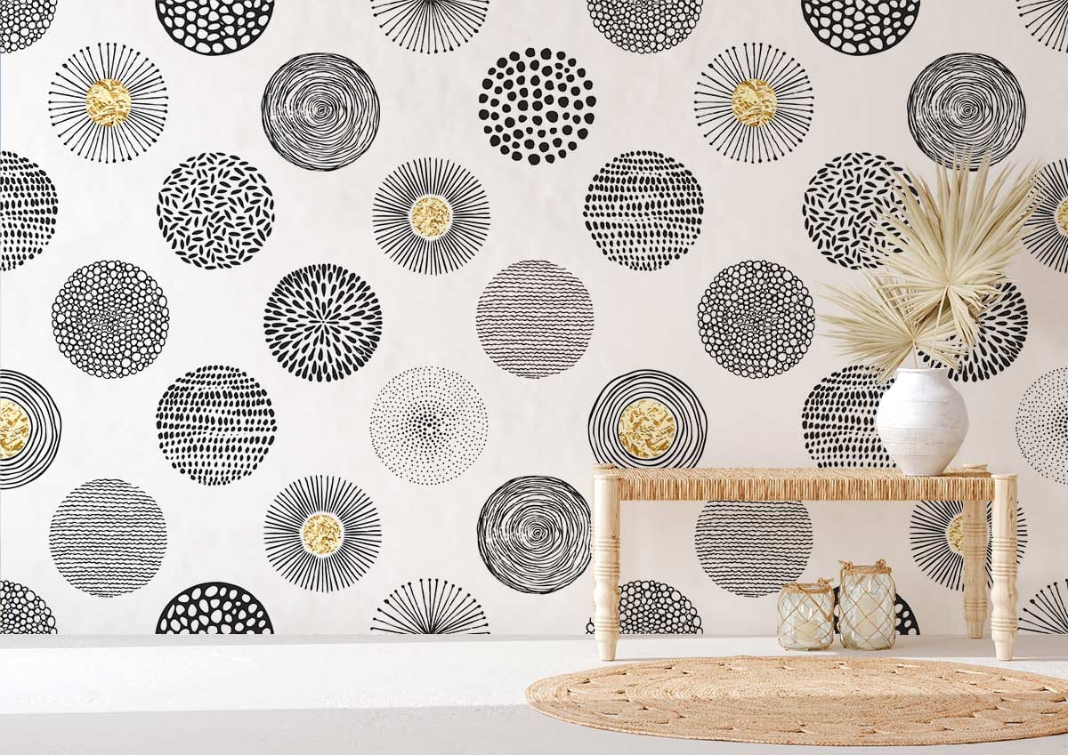 Monochrome geometric circles gold accents wallpaper in modern room with light wooden bench and beige rug.