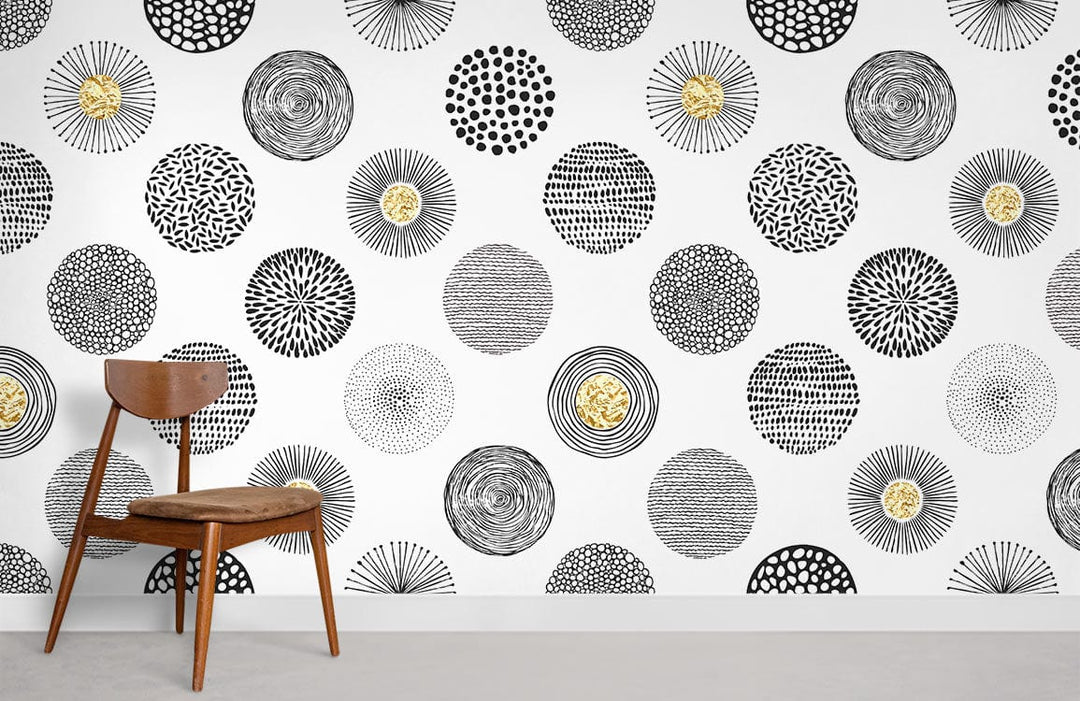 Monochrome geometric circles wallpaper with gold accents, wooden chair, modern minimalist room setting.