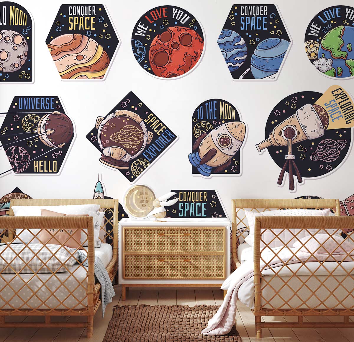 Double beds in child's room, Vintage Space Adventure Wallpaper; cosmic planets, rockets; wicker drawers, wood flooring.