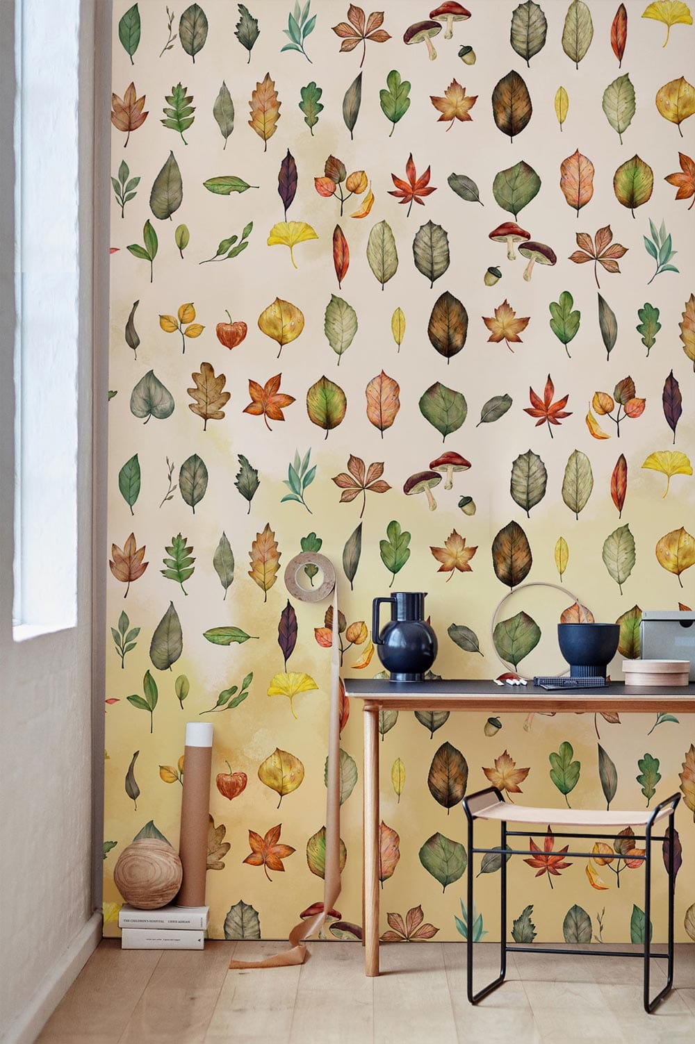 Autumn Leaves Watercolour Wallpaper in stylish workspace with wooden desk and modern chair, light flooring.