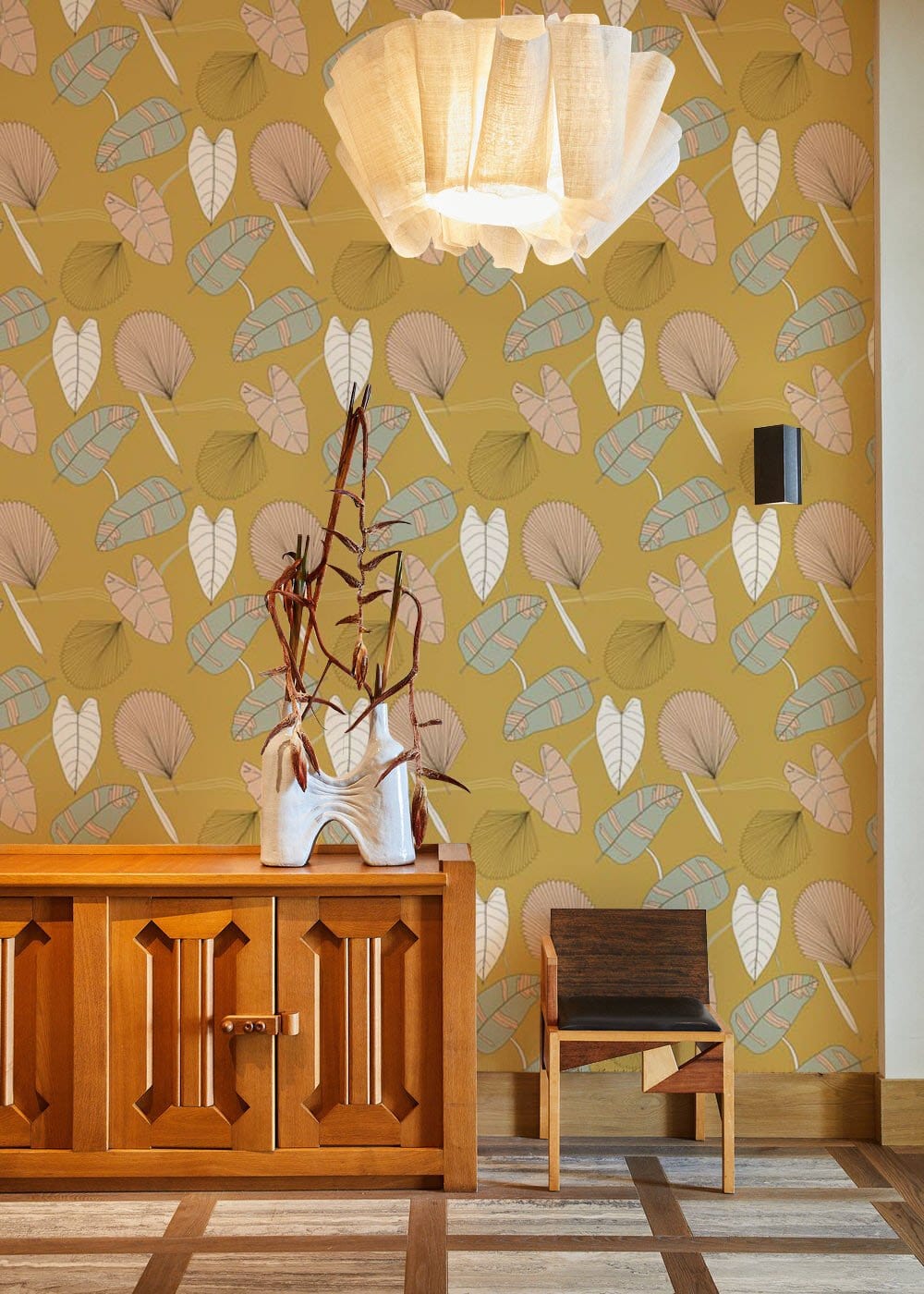 Vintage Botanical Leaf Pattern Wallpaper in mustard, pastel shades; wooden cabinet, chair, pendant light.