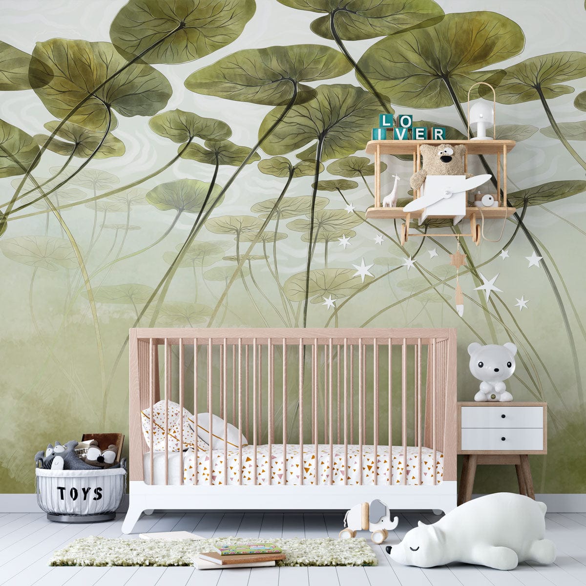 Green lotus pond mural wallpaper, nursery room, white crib, pastel decor, wooden flooring, whimsical design.
